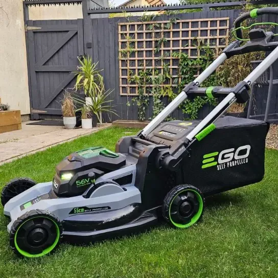 Modern electric battery-powered lawn mower for eco-friendly lawn care